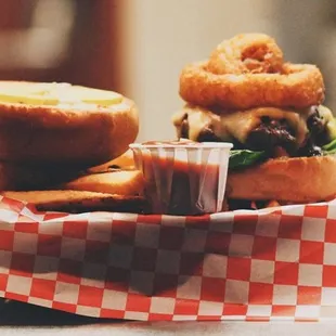 a burger and onion rings in a basket