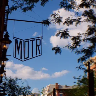 a sign hanging from the side of a building