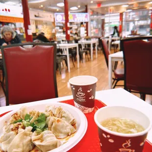 a plate of dumplings and a cup of soup