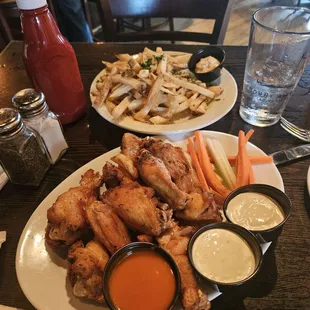 Naked wings with Buffalo, ranch and blue cheese sauces and Parmesan truffle fries