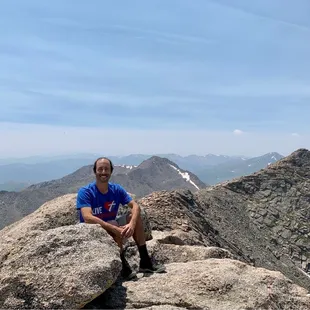 Taking a rest to appreciate the surroundings along The Trail Hike at the top of Mount Evans.