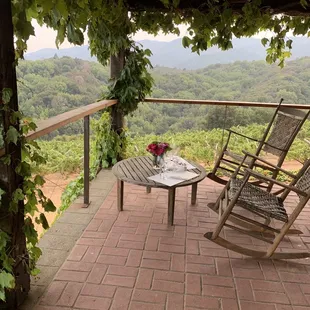 a patio with chairs and a table