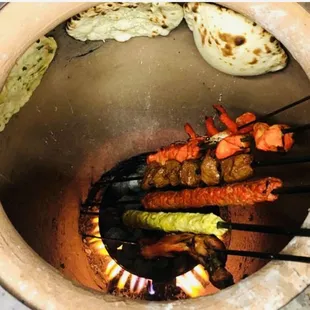 skewers of food being cooked