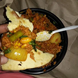 Vegetable biryani and on garlic naan