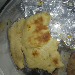 a piece of flat bread in a plastic container