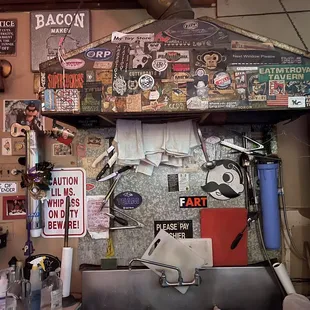 a bar with a bunch of stickers on the wall