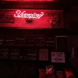 a neon sign above the bar