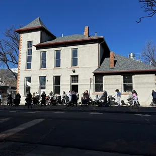 a group of people sitting outside a building