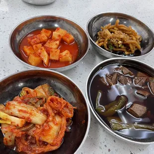 three bowls of food on a table