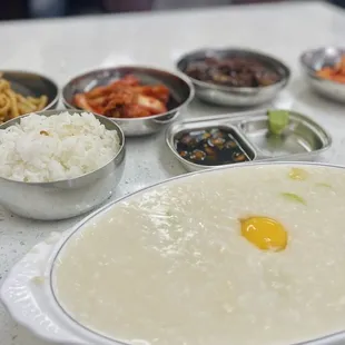 a bowl of porridget and bowls of rice