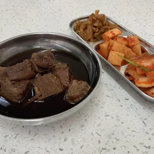 two dishes of beef and vegetables
