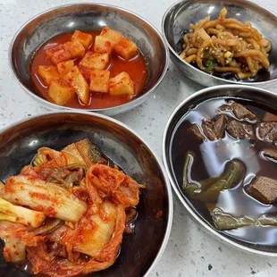 three bowls of food on a table