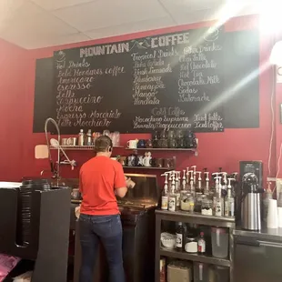 Inside. Owner is making coffee for customer. Menu is shown at the back.