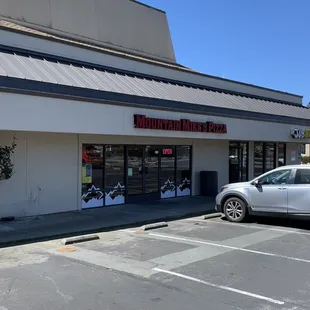 a car parked in front of the store