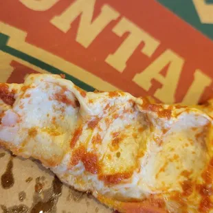 Raw pizza dough. Cheese has been removed, that is raw dough not cheese.