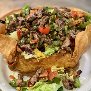 a taco salad in a tortilla basket