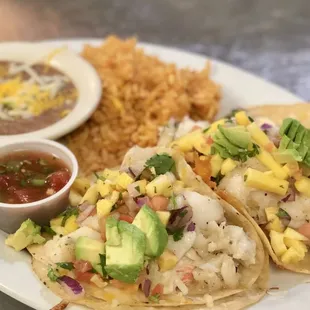 a plate of tacos and a bowl of salsa
