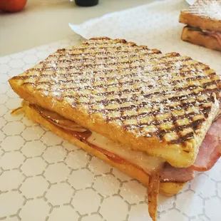 Shavano Cristo
Honey roasted Turkey along with smokehouse ham, grilled between sourdough and Swiss cheese. Paired up with raspberry jelly