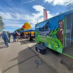 people walking around a food truck