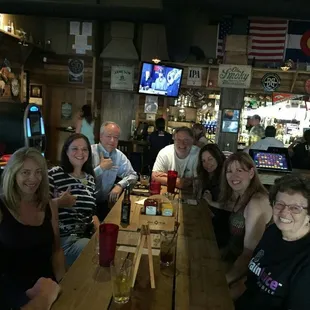 a group of people sitting at a bar