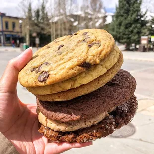 a hand holding a stack of cookies