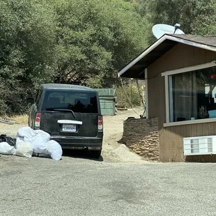 Pillow cases full of laundry dumped on the ground.