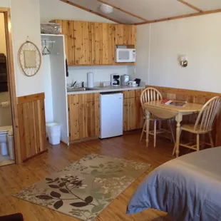 Cabin with one queen size bed, features microwave, fridge, coffee maker &amp; mugs.