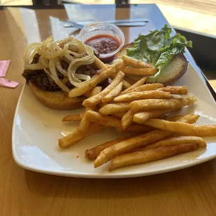 Bbq beef sandwich with grilled onions and crunchy fries