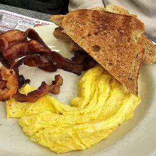 Scrambled eggs, bacon, and toast