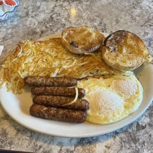 Link sausage and eggs over medium, hash browns and English muffin.