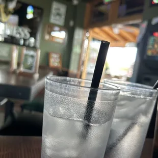 two glasses of water with a straw