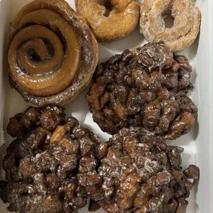 Blueberry fritters, cinnamon roll, cake donuts, cinnamon sugar donut