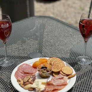 Sparkling wine and charcuterie plate outside seating