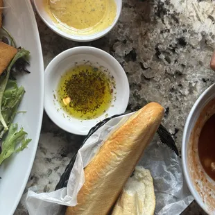 Fresh bread with garlic butter and olive oil with herb dipping sauces.
