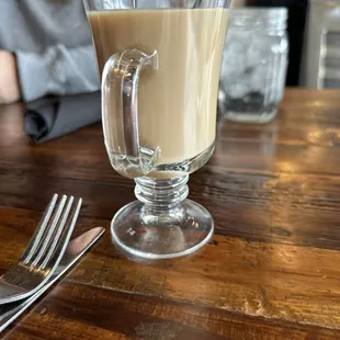 a cup of coffee and a fork