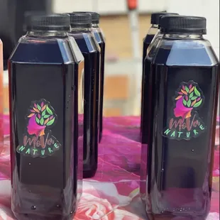 three bottles of juice on a table