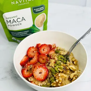 a bowl of oatmeal and a bag of maca powder