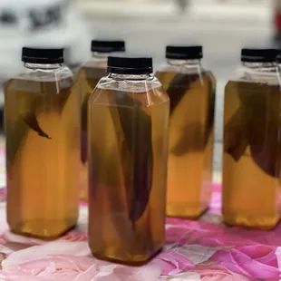 a row of four bottles of liquid