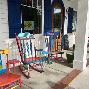 a row of colorful rocking chairs