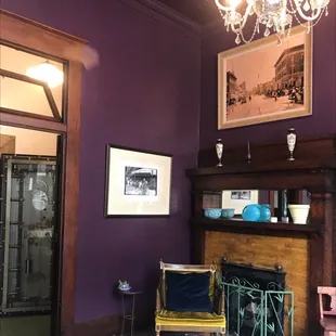 a purple room with a chandelier