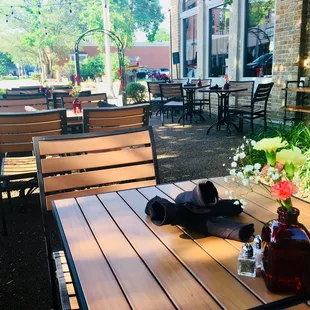 a wooden table and chairs outside