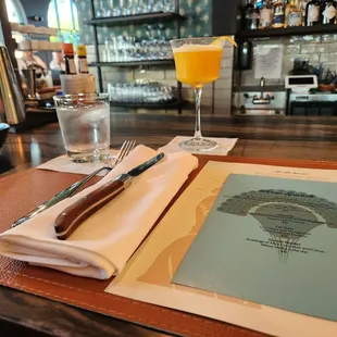 Bar seating - placemat, cocktail menu, and the Island 75 cocktail