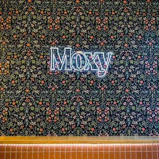 a neon sign that reads moxy