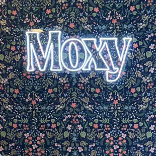 a neon sign that says moxy