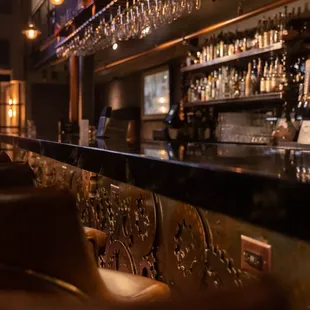 a bar with brown leather chairs