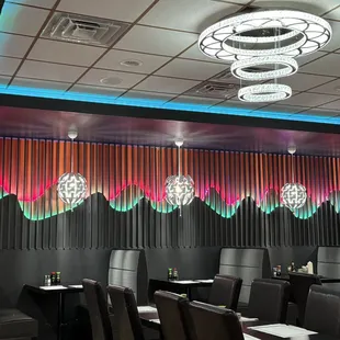 Booths inside restaurant, lights and decorations.