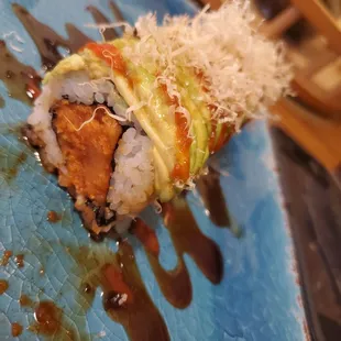 a close up of a sushi roll on a blue plate