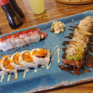 a plate of sushi with sauce and sauce