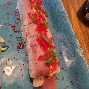 a sushi roll on a blue plate
