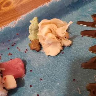 a plate of sushi on a blue plate